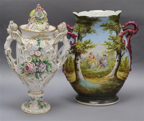 A putti handled lipped flower encrusted Sitzendorf style vase and a two handled pastoral scene vase tallest 36cm